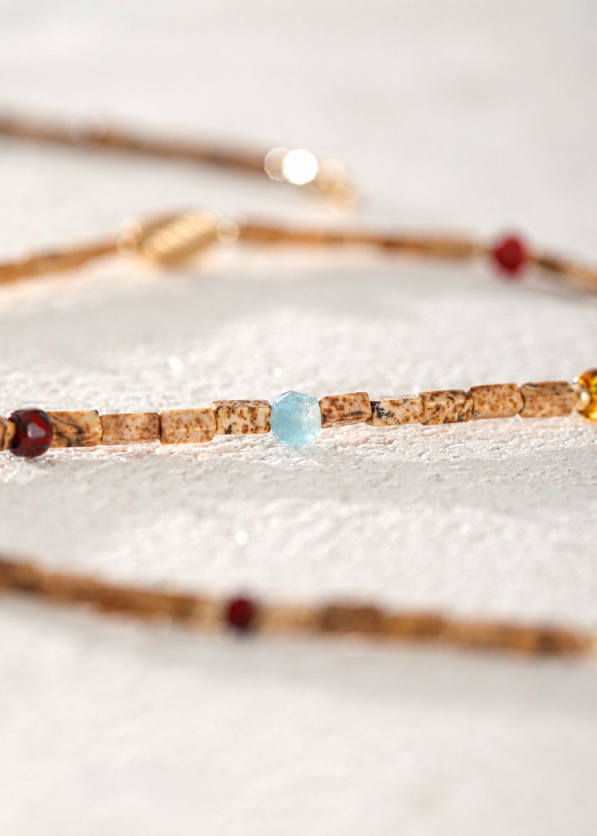 Close-up of landscape jasper rectangles and colored accent beads