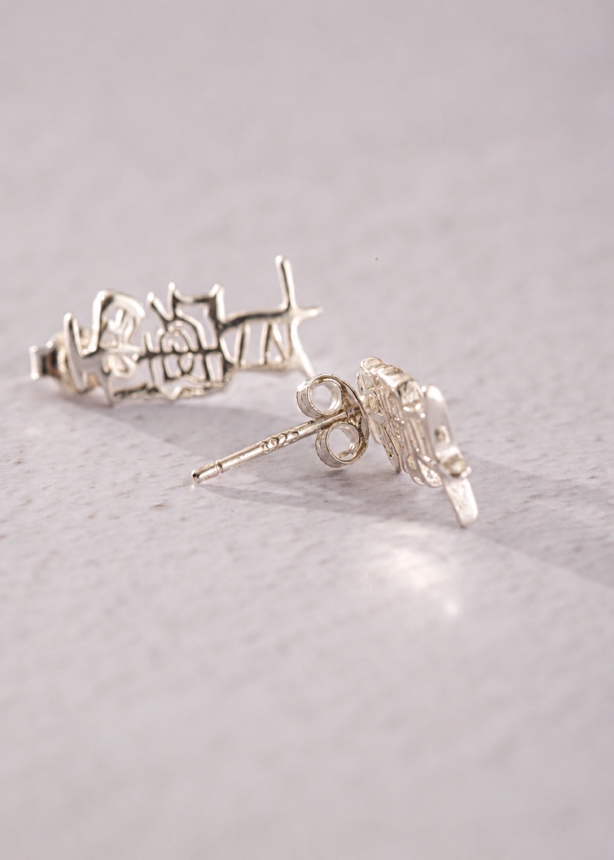 Taoist Amulet studs showing calligraphic shapes, posts and butterfly backs