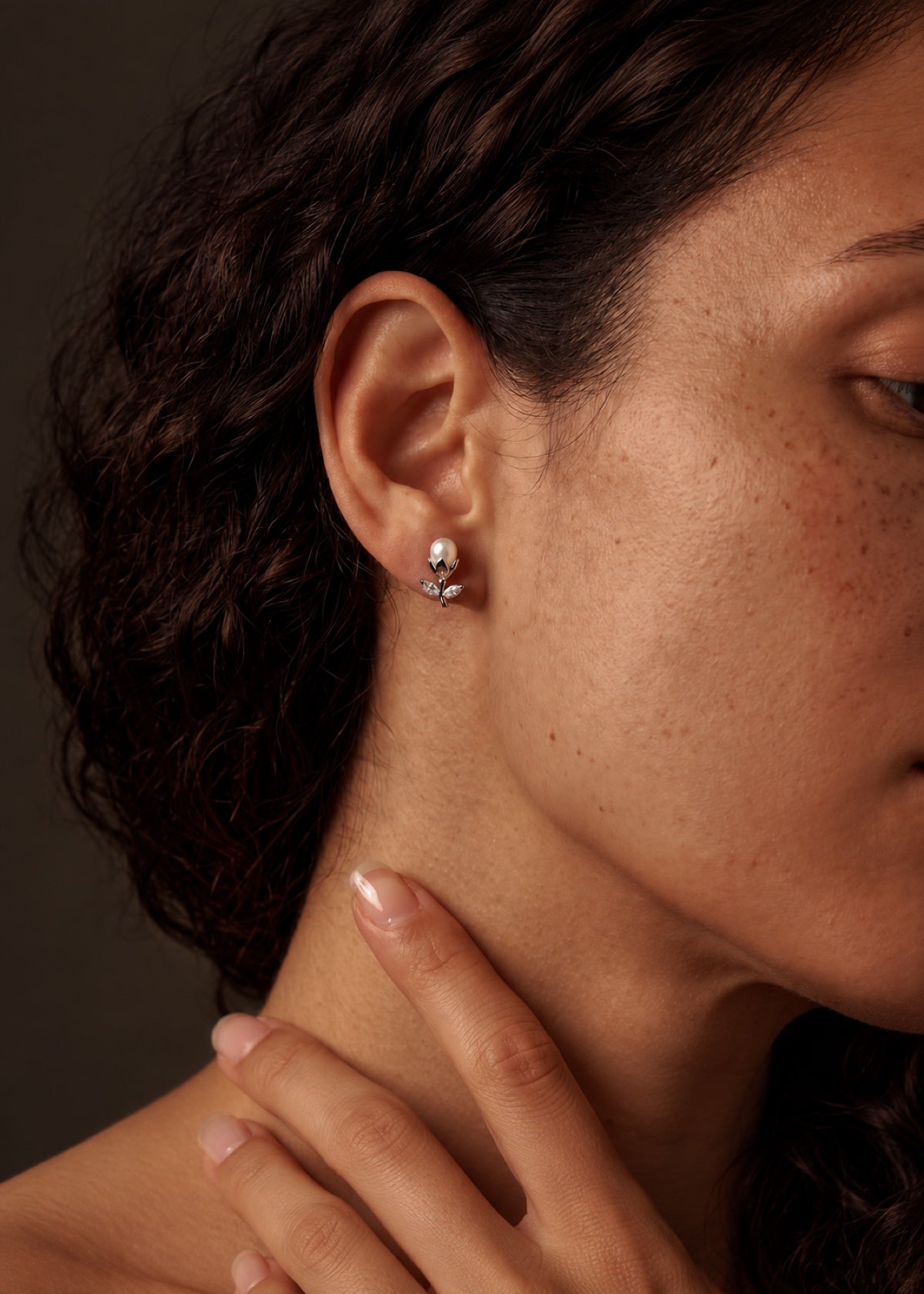 Tulip pearl stud worn with hair in a bun