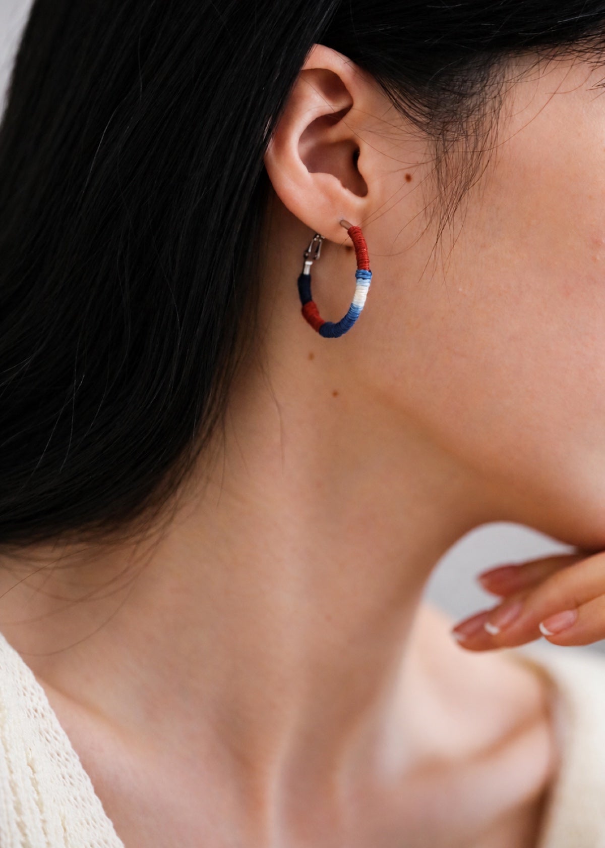 Shibori textile hoop earring worn beside dark hair