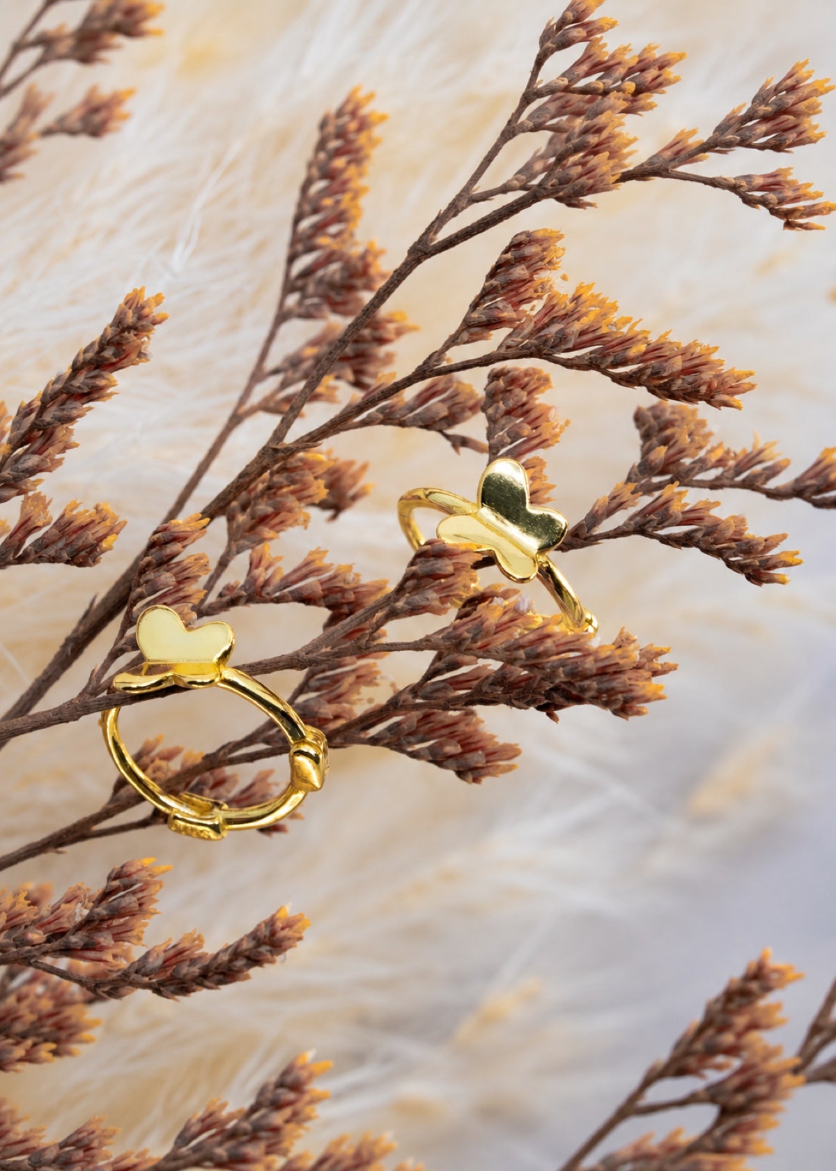 Butterfly Huggies hanging from dried flower stems
