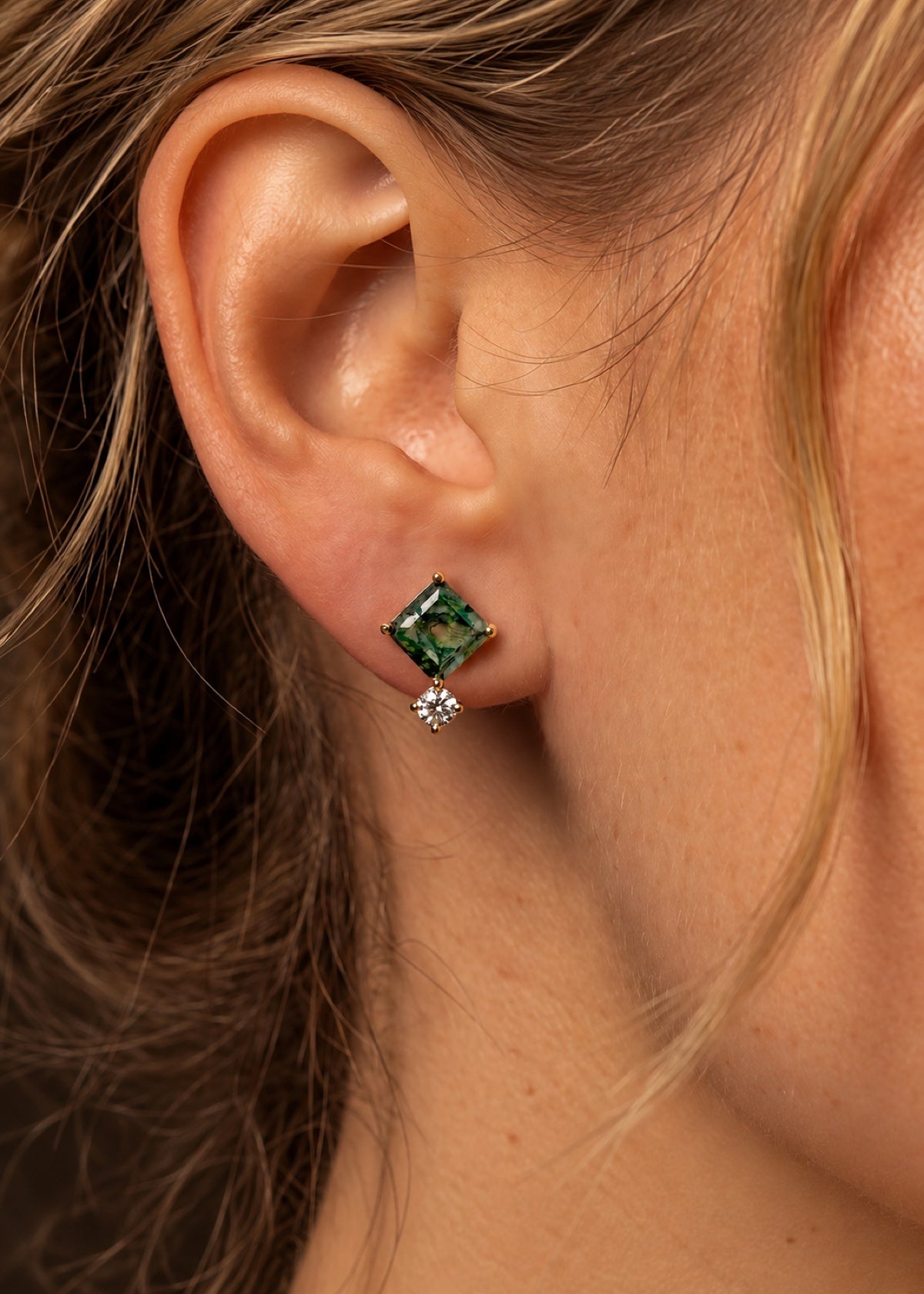 Square moss agate huggie worn in an earlobe, front view