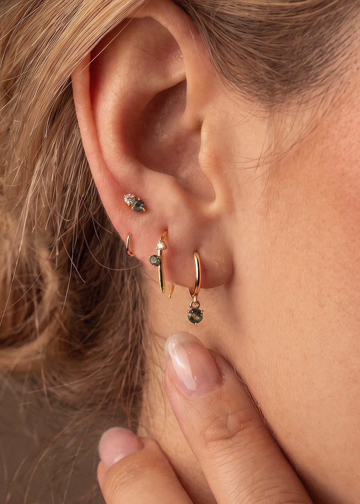 Gold Monet-inspired moss agate huggies and studs worn as an ear stack