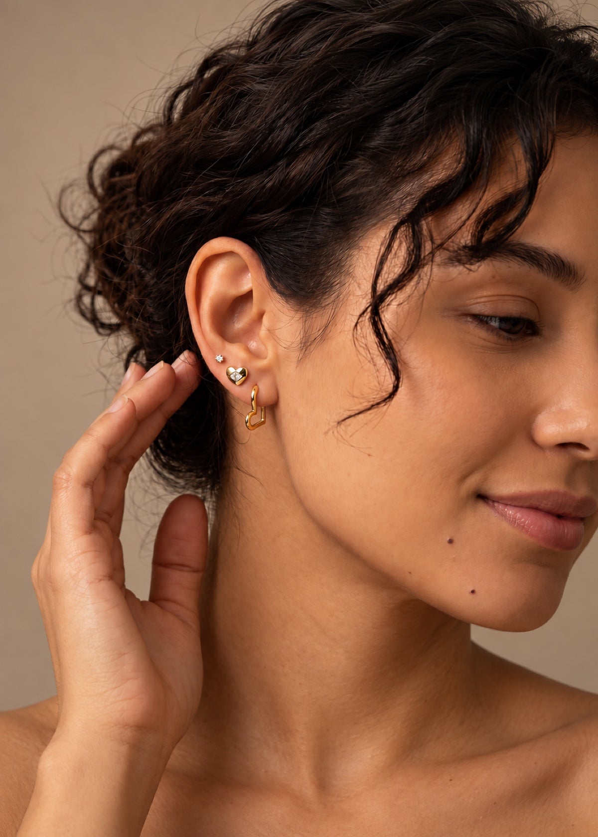 Heart earring set worn beside swept-back hair