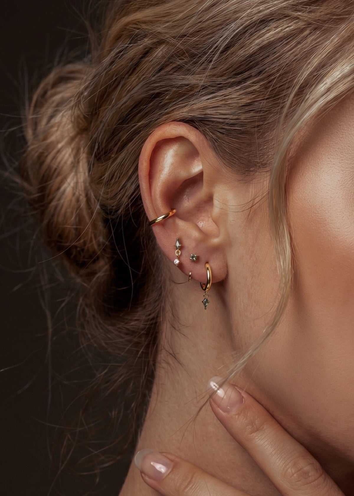 Moss agate huggies and studs styled across the earlobe and upper cartilage